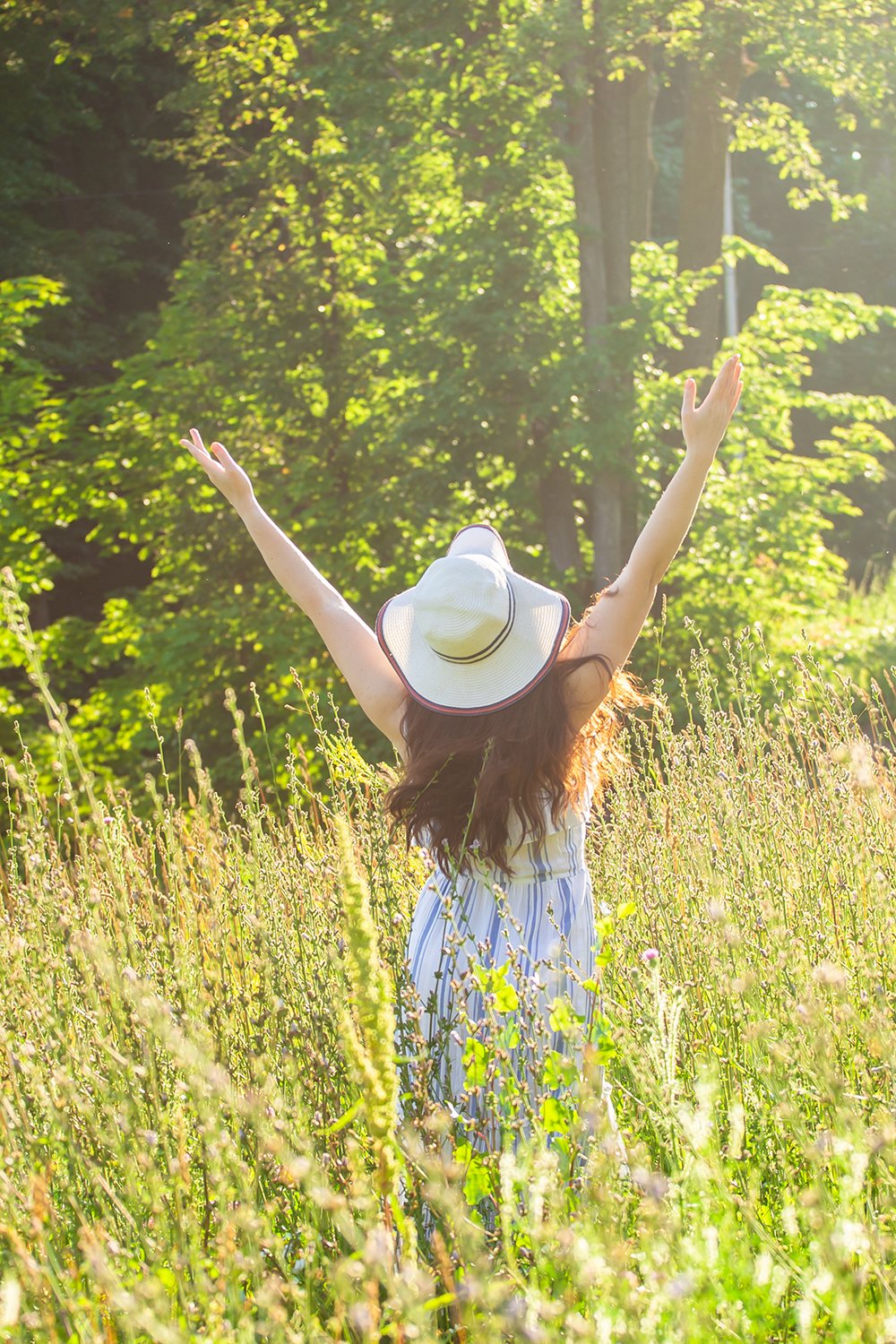 happy woman in field with no worries of Lyme disease